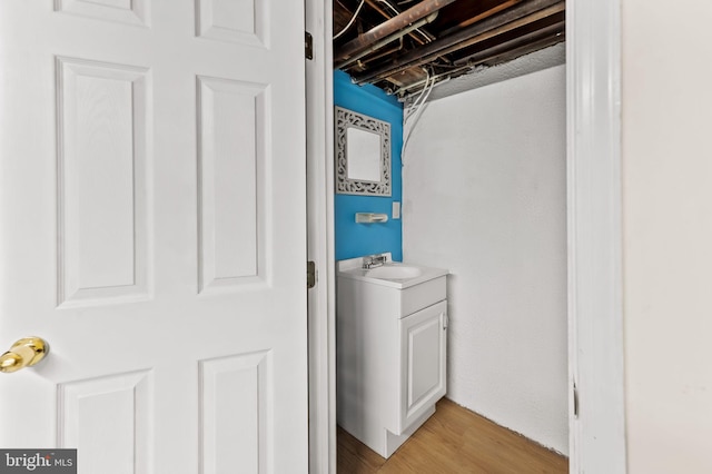 washroom featuring light wood-type flooring and a sink