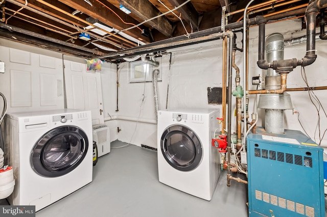 clothes washing area with washing machine and clothes dryer, laundry area, and a heating unit