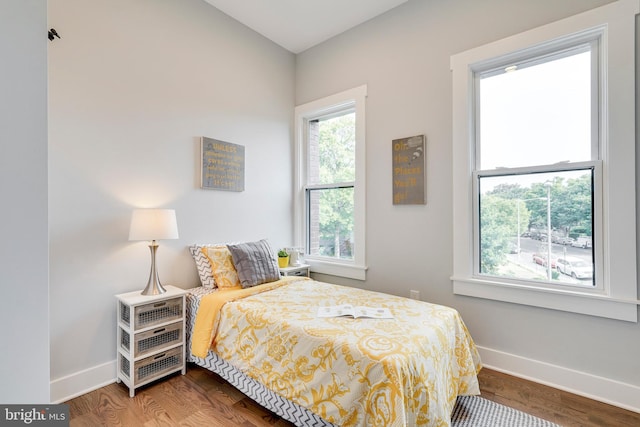 bedroom with baseboards and wood finished floors