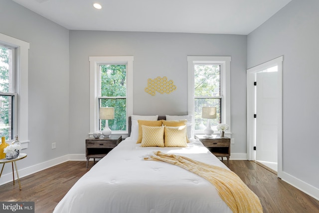 bedroom featuring dark wood finished floors, recessed lighting, and baseboards