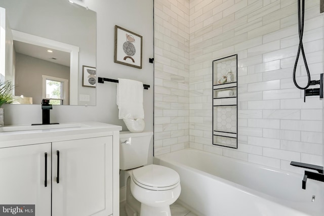 bathroom with toilet, vanity, and washtub / shower combination