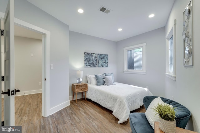 bedroom featuring visible vents, recessed lighting, wood finished floors, and baseboards