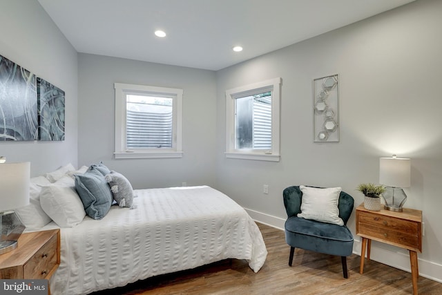 bedroom with recessed lighting, baseboards, and wood finished floors