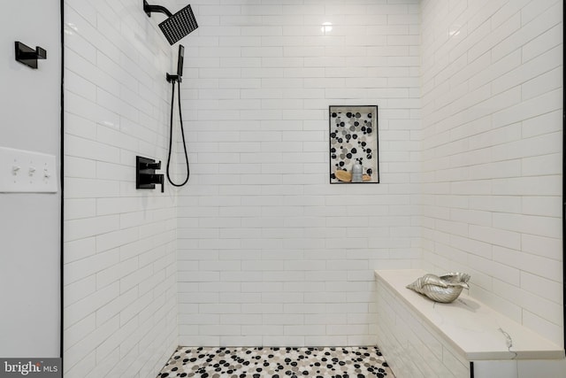 full bath featuring tiled shower