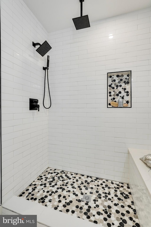 bathroom with a tile shower