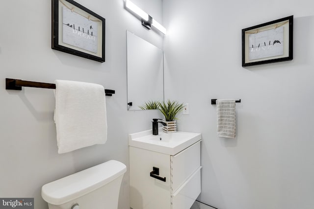 half bathroom featuring toilet and vanity