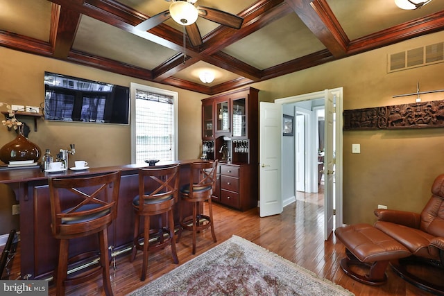 bar featuring dark wood finished floors, visible vents, and coffered ceiling