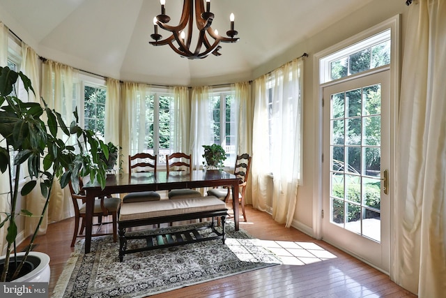 sunroom / solarium with vaulted ceiling and a notable chandelier