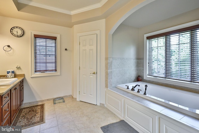 full bathroom with baseboards, a tray ceiling, ornamental molding, a bath, and vanity