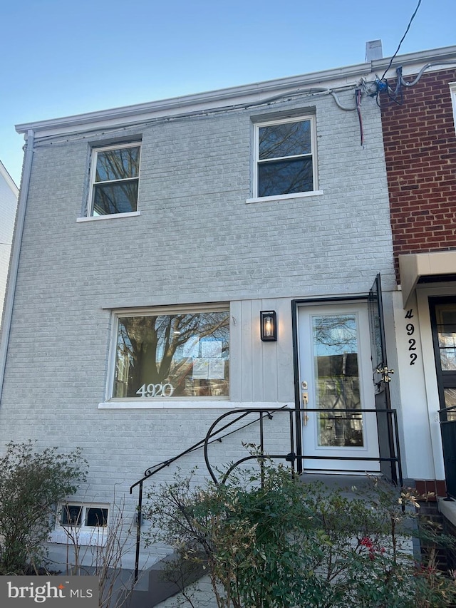 back of property featuring brick siding