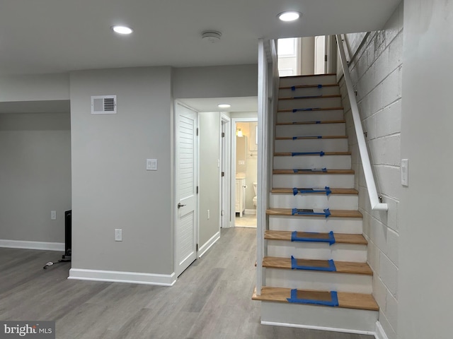 staircase with visible vents, recessed lighting, baseboards, and wood finished floors