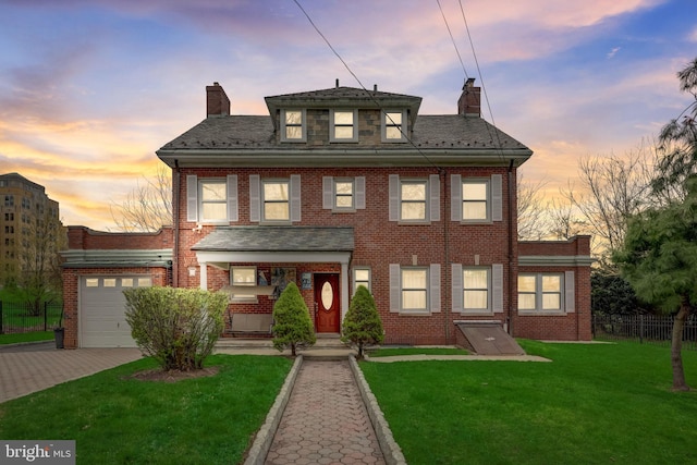 view of front of house featuring brick siding, fence, a front yard, a chimney, and decorative driveway