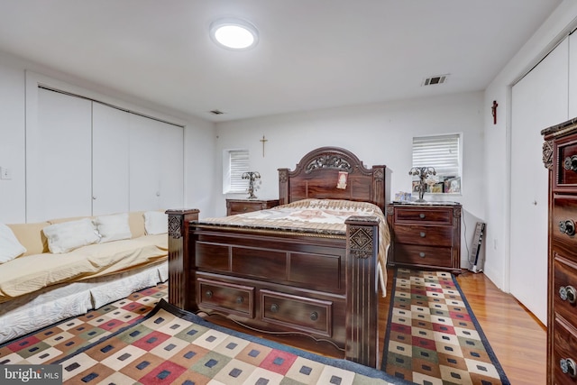 bedroom featuring a closet, visible vents, and light wood finished floors