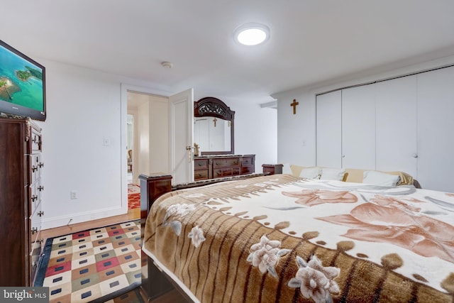 bedroom with a closet and baseboards