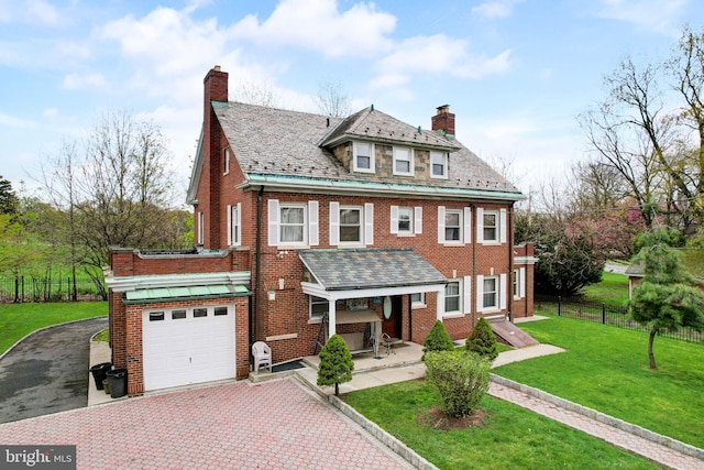 view of front of home with brick siding, a high end roof, and a front lawn