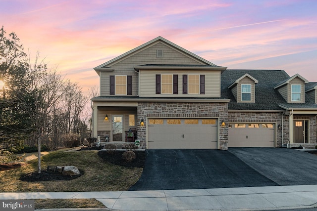 view of front of house featuring aphalt driveway, stone siding, a garage, and roof with shingles