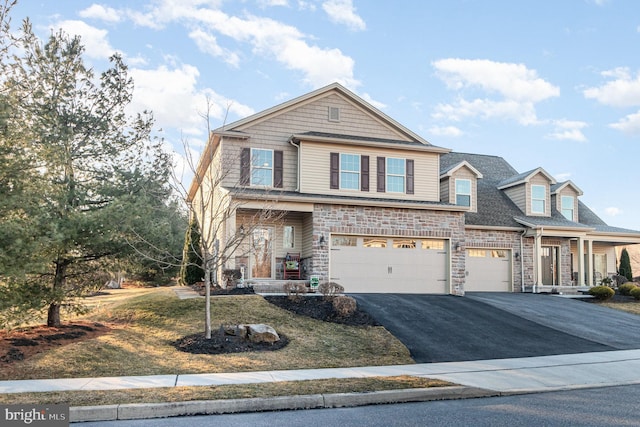 view of front of house with aphalt driveway and a garage