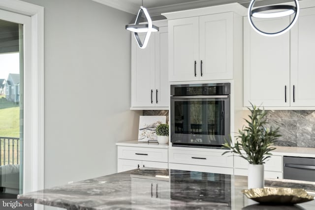 interior details featuring stainless steel oven, decorative backsplash, light stone counters, and crown molding