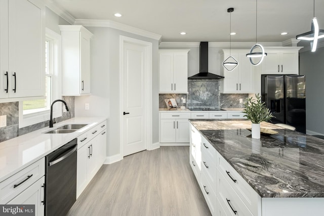 kitchen with stainless steel refrigerator with ice dispenser, a sink, black stovetop, wall chimney range hood, and dishwashing machine