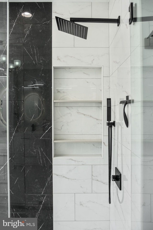 bathroom with a marble finish shower