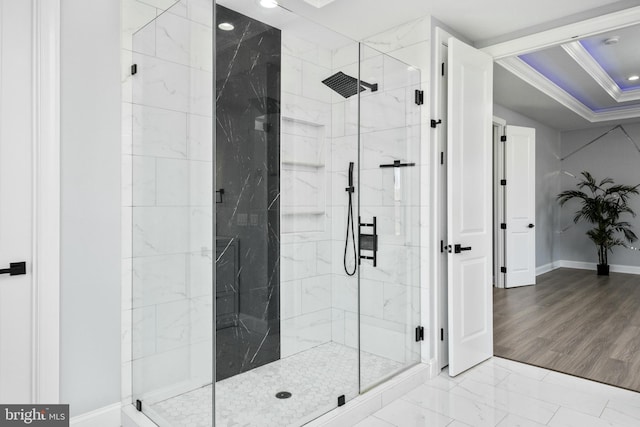 full bath featuring marble finish floor, baseboards, a marble finish shower, and ornamental molding