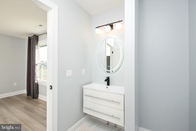 bathroom with visible vents, vanity, and baseboards