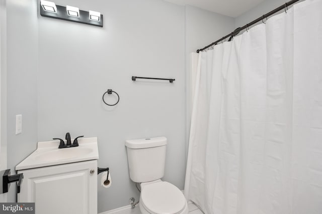 bathroom featuring vanity, curtained shower, and toilet