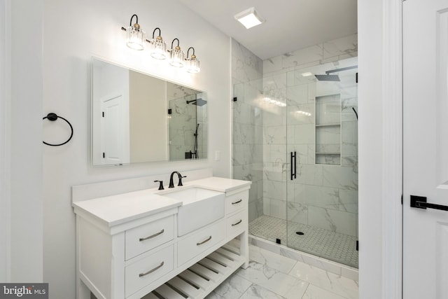 full bath featuring marble finish floor, a stall shower, and vanity