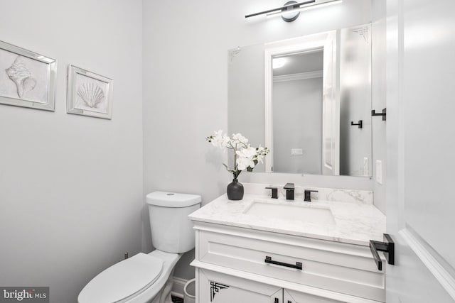 half bath featuring toilet and vanity