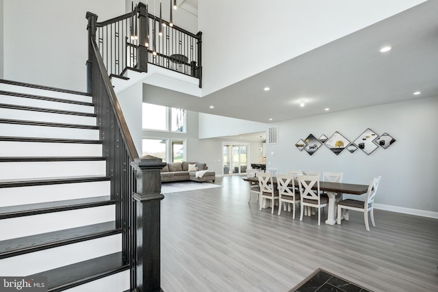 dining space featuring stairway, recessed lighting, baseboards, and wood finished floors