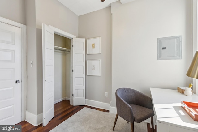 office space featuring electric panel, dark wood-style floors, and baseboards