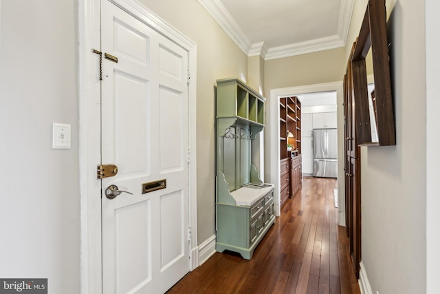 hallway with ornamental molding, baseboards, and dark wood-style flooring