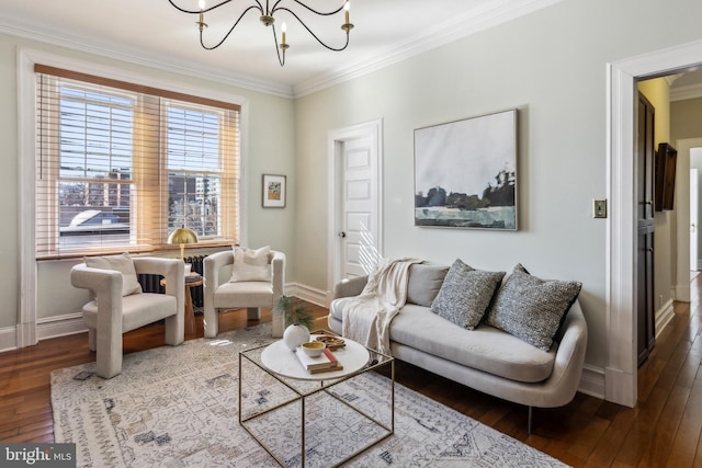 living room with ornamental molding, baseboards, wood-type flooring, and a chandelier