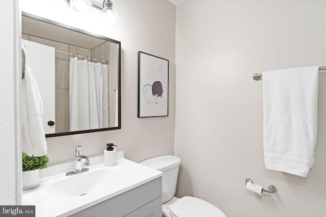 bathroom featuring vanity, toilet, and a shower with curtain