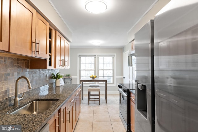 kitchen featuring light tile patterned floors, a sink, decorative backsplash, black range with electric cooktop, and stainless steel refrigerator with ice dispenser