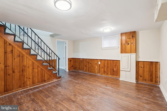 interior space featuring a wainscoted wall, wood finished floors, and stairs