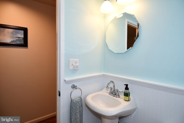 bathroom featuring a sink and wainscoting