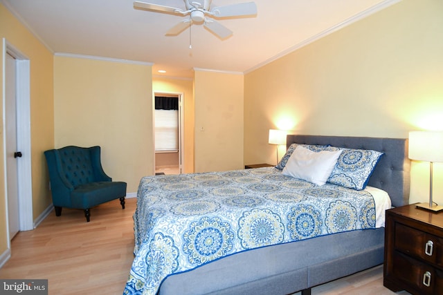 bedroom with crown molding, a ceiling fan, baseboards, and light wood finished floors