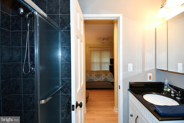 full bathroom with vanity, ensuite bath, wood finished floors, and a stall shower