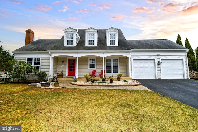 view of front of home featuring aphalt driveway, a shingled roof, covered porch, a front yard, and an attached garage