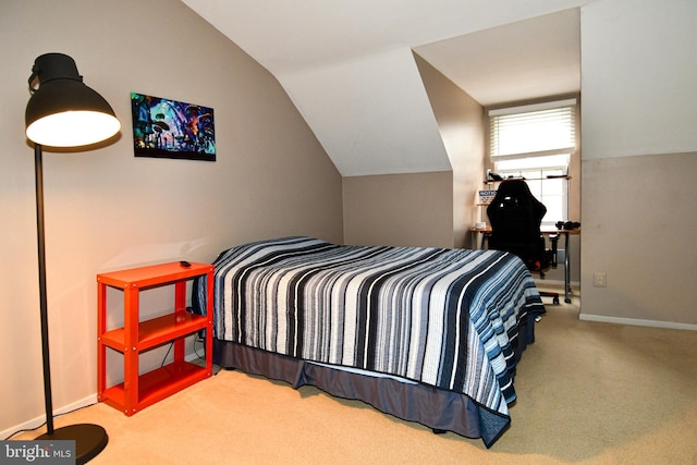 bedroom with baseboards, lofted ceiling, and carpet floors