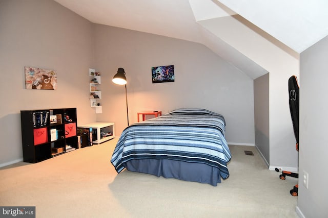 bedroom featuring baseboards, lofted ceiling, visible vents, and carpet flooring