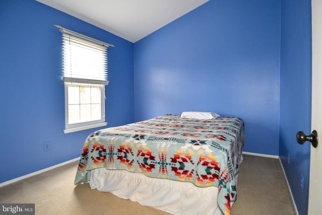 carpeted bedroom featuring baseboards