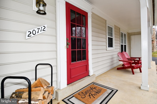 view of exterior entry featuring a porch