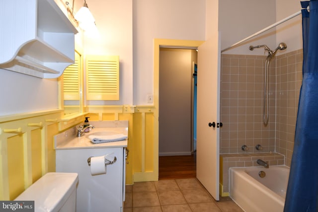 bathroom with tile patterned flooring, shower / bath combo with shower curtain, and vanity