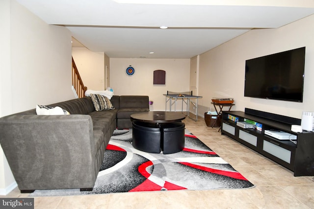 living area featuring stairway and light tile patterned flooring