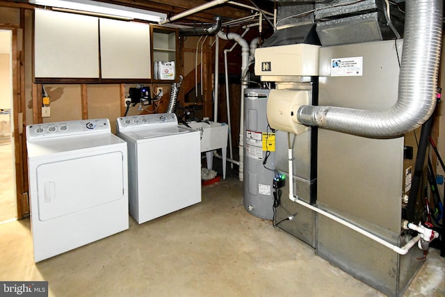 interior space featuring washing machine and dryer, water heater, and a sink