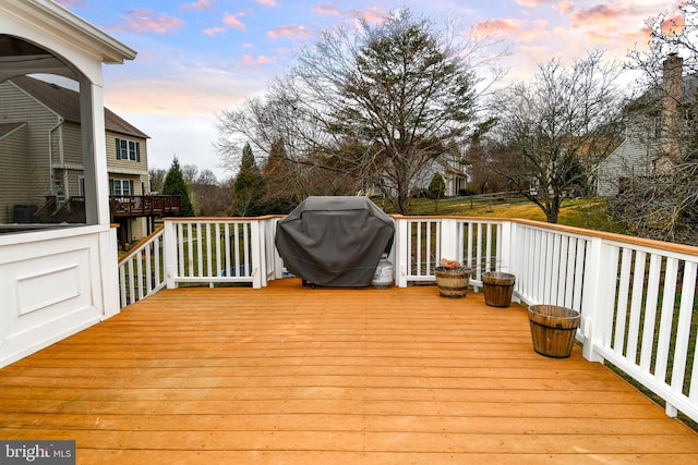 deck at dusk with a grill