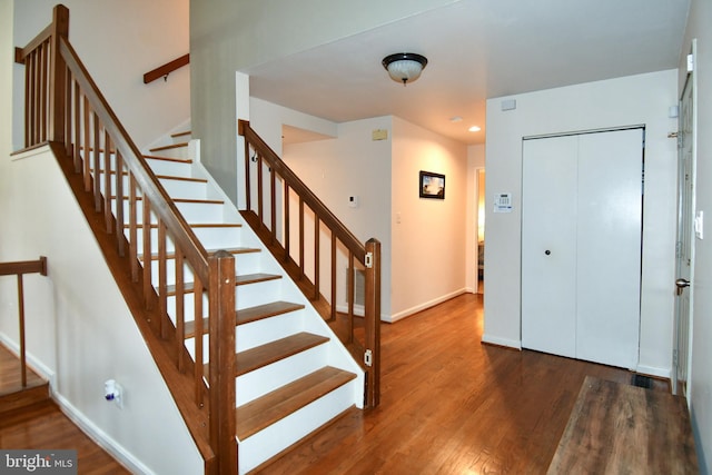 foyer with stairway, recessed lighting, wood finished floors, and baseboards