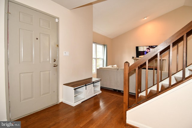 foyer entrance with stairway, lofted ceiling, and dark wood-style floors